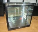 Custom Black Cabinet with Glass Shelves by Showfront